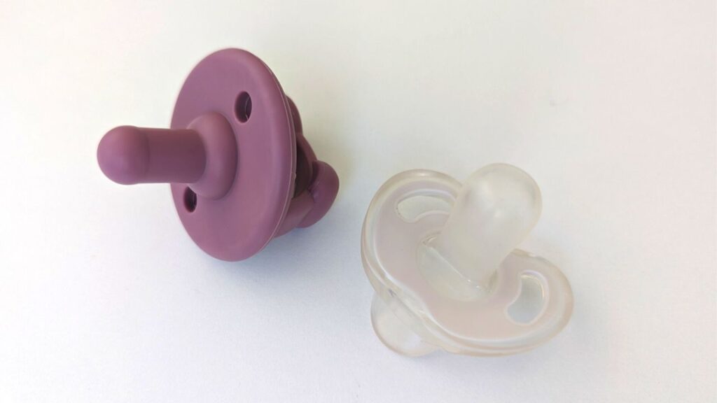 purple itzy ritzy silicone pacifier and white tommee tippee ultra light silicone pacifier