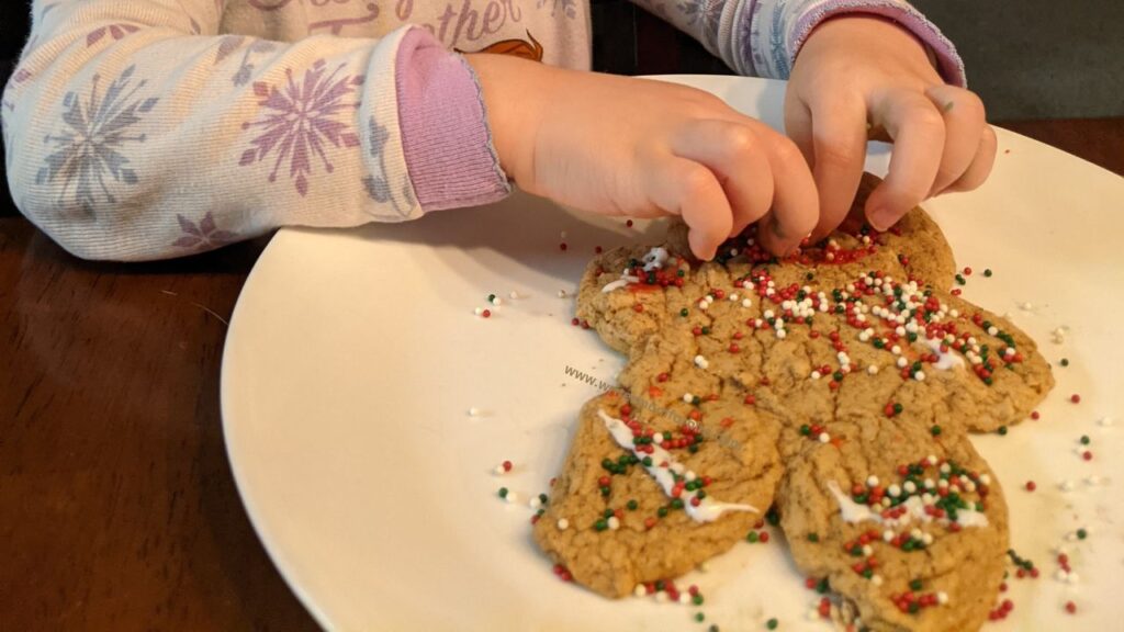 my daughter checking "decorate gingerbread men" off our christmas bucket list