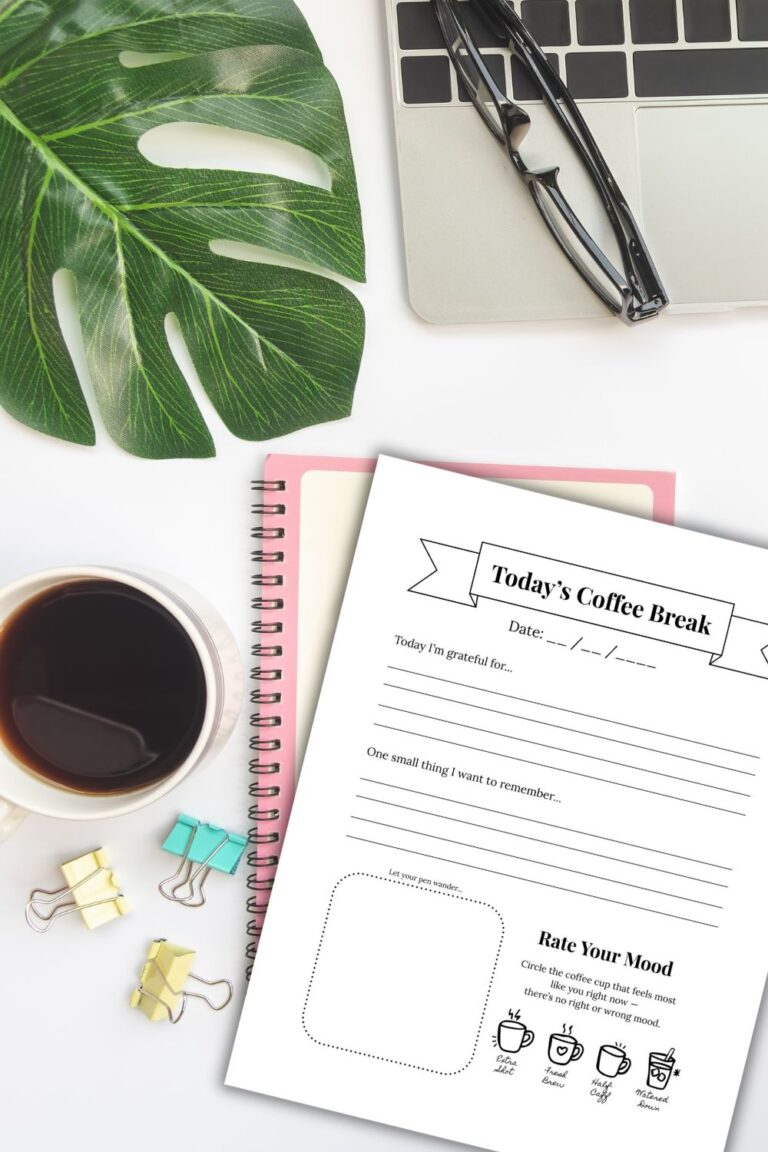 desk with plant, coffee, binder clips, glasses, laptop, notebook and my "today's coffee break" printable page